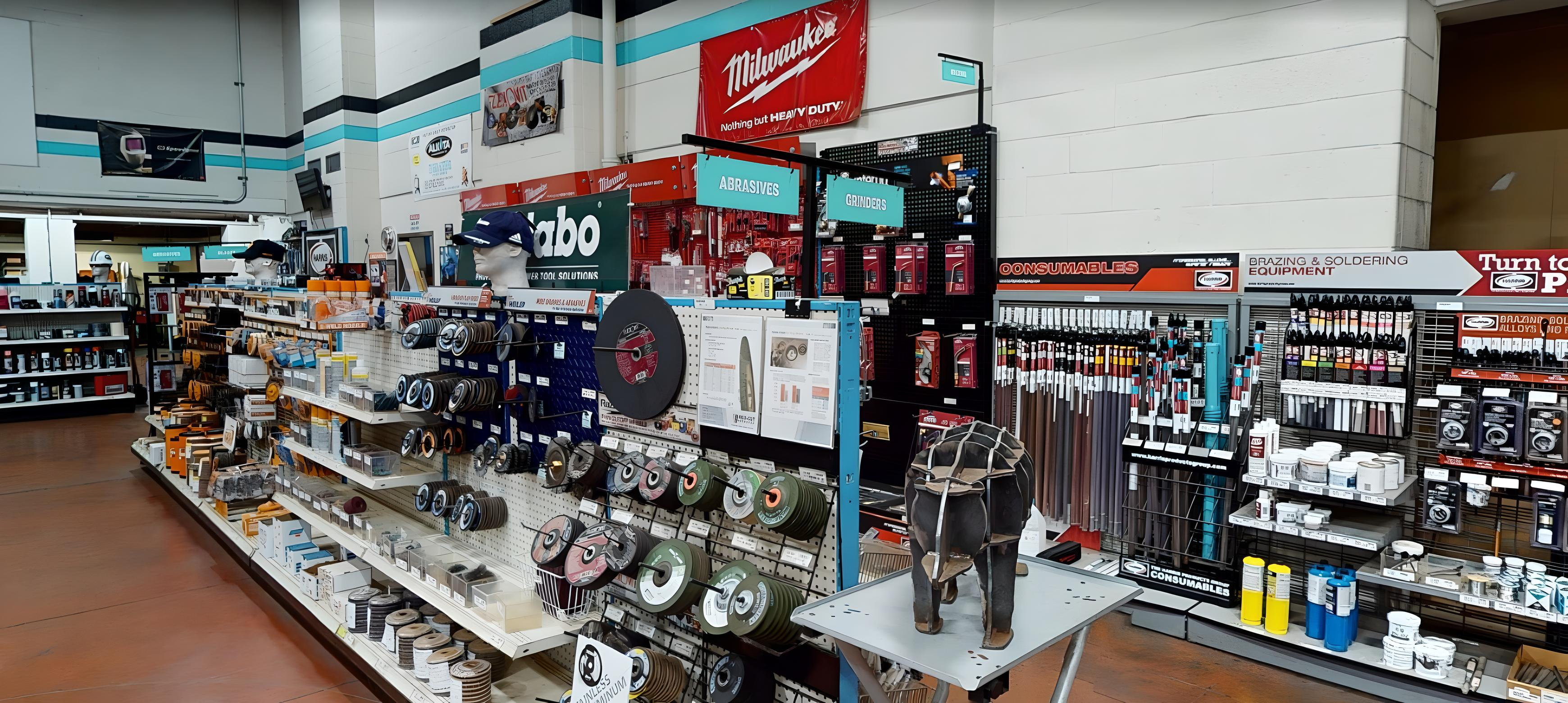Close-up of heavy-duty aisle sign holder mounted to gondola upright in welding supply store.